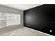 A simple but nice bedroom with a modern look, featuring a dark accent wall and big window for natural lighting at 2352 Grand Central Pkwy # 18, Orlando, FL 32839