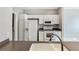 Bright kitchen with white cabinets, laminate countertops, stainless appliances, and tile flooring at 2352 Grand Central Pkwy # 18, Orlando, FL 32839