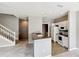 Bright kitchen with white cabinets, stainless steel appliances, tile flooring, and access to stairs at 2352 Grand Central Pkwy # 18, Orlando, FL 32839