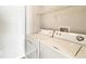 Convenient laundry room featuring a washer and dryer, and practical shelving for storage at 2352 Grand Central Pkwy # 18, Orlando, FL 32839