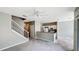 Open-plan living area with stairs, white ceiling fan, access to the kitchen, and neutral colored carpet at 2352 Grand Central Pkwy # 18, Orlando, FL 32839