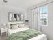 Cozy bedroom with a queen-sized bed, side tables, and a window for natural light at 608 Terrapin Dr, Debary, FL 32713