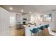 Modern kitchen features an island with bar seating, stainless steel appliances, and ample cabinet space at 608 Terrapin Dr, Debary, FL 32713