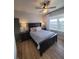 Stylish bedroom with dark furniture, ceiling fan, and natural light at 166 Catfish St, Haines City, FL 33844