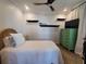 Relaxing bedroom featuring a patterned bedspread, ceiling fan, and rustic accents at 166 Catfish St, Haines City, FL 33844