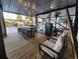Spacious outdoor kitchen on the water with bar seating and relaxing lounge area at 166 Catfish St, Haines City, FL 33844