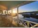 Covered porch with wooden rocking chairs overlooking a scenic waterfront at sunset at 166 Catfish St, Haines City, FL 33844