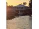 Waterfront home with boat lift and picturesque water views at sunset at 166 Catfish St, Haines City, FL 33844