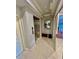 Hallway view with elevator, tiled floor and decor in neutral colors at 10091 Lake Cove Dr # 301, Fort Myers, FL 33908