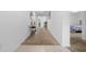 Bright hallway with tiled floors at entrance leading to carpet and bedroom at 1065 Mattie Pointe Way, Auburndale, FL 33823