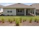 Lovely backyard featuring a covered patio and green lawn at 2797 Top Hill Ct, Minneola, FL 34715