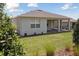 Green backyard featuring a covered patio and well-maintained lawn at 2797 Top Hill Ct, Minneola, FL 34715