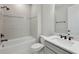 Bright and modern bathroom with tiled tub, shower, and vanity featuring sleek fixtures and finishes at 2797 Top Hill Ct, Minneola, FL 34715