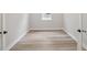 Bright bedroom featuring modern wood-look floors and neutral wall paint at 2797 Top Hill Ct, Minneola, FL 34715