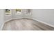 Bedroom with hardwood flooring, light-colored walls, white trim, and natural light from the windows at 2797 Top Hill Ct, Minneola, FL 34715