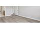 Minimalist bedroom with hardwood floors, gray walls, and doorway to bathroom at 2797 Top Hill Ct, Minneola, FL 34715