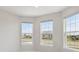 Well-lit room featuring bright white walls, multiple large windows with great street and community views at 2797 Top Hill Ct, Minneola, FL 34715
