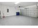 Spacious two-car garage with sealed concrete floors and an electric garage door at 2797 Top Hill Ct, Minneola, FL 34715