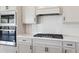 Modern kitchen with white countertops and cabinets, stainless steel appliances, and a gas range at 2797 Top Hill Ct, Minneola, FL 34715