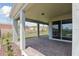 Covered outdoor patio with brick flooring, offering a relaxing space overlooking the landscaped backyard at 2797 Top Hill Ct, Minneola, FL 34715