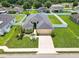 An aerial view of a well-manicured property featuring lush green lawn and white vinyl fencing at 4662 Harts Brook Ln, Mulberry, FL 33860
