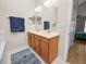 Bright bathroom features a double sink vanity with a large mirror and neutral tones at 4662 Harts Brook Ln, Mulberry, FL 33860