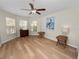 Bedroom with hardwood floors, ceiling fan, three windows and a dresser at 4662 Harts Brook Ln, Mulberry, FL 33860
