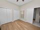 Bright bedroom with wood-look flooring, a ceiling fan and large closet at 4662 Harts Brook Ln, Mulberry, FL 33860
