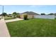 Well-manicured front yard with lush green lawn and mature landscaping at 4662 Harts Brook Ln, Mulberry, FL 33860