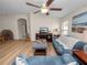 A cozy living room is brightly lit from the natural light and fan at 4662 Harts Brook Ln, Mulberry, FL 33860