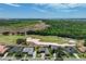 Stunning aerial view showcasing the proximity to a golf course and vast green spaces, providing a serene backdrop at 655 Whisper Woods Dr, Lakeland, FL 33813