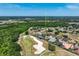 Aerial view of a home near a golf course, surrounded by lush greenery, offering a tranquil and scenic setting at 655 Whisper Woods Dr, Lakeland, FL 33813