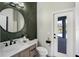 Stylish bathroom with a decorative mirror, modern vanity, and convenient access to the pool area at 655 Whisper Woods Dr, Lakeland, FL 33813