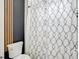 Stylish bathroom with a modern toilet and patterned shower curtain, offering a blend of comfort and contemporary design at 655 Whisper Woods Dr, Lakeland, FL 33813
