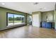 Bright bonus room featuring a large window with attractive golf course views and stylish decor at 655 Whisper Woods Dr, Lakeland, FL 33813