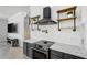 Modern kitchen featuring black appliances, open shelving, and a stylish range hood at 655 Whisper Woods Dr, Lakeland, FL 33813