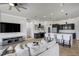 Comfortable living room with wood floors, a gray sofa, and stylish decor with an open view to the kitchen at 655 Whisper Woods Dr, Lakeland, FL 33813