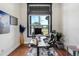 Bright home office featuring a desk setup, wood floors, and a large window with outdoor views at 655 Whisper Woods Dr, Lakeland, FL 33813