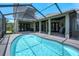 Stunning screened-in pool and patio area perfect for outdoor relaxation and entertainment with covered outdoor living spaces at 655 Whisper Woods Dr, Lakeland, FL 33813