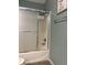 Bathroom shower with sliding glass door and updated showerhead; features neutral wall paint and artwork at 1087 Jackson St, The Villages, FL 32162