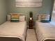 Comfortable bedroom featuring two twin beds, soft linens, and a calming color palette for restful nights at 1087 Jackson St, The Villages, FL 32162