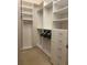 Walk-in closet with white shelving, multiple hanging rods, and drawers for optimal storage solutions at 1087 Jackson St, The Villages, FL 32162
