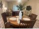 Cozy dining area with a round wooden table, chairs, and stylish decor, perfect for Gathering meals at 1087 Jackson St, The Villages, FL 32162