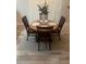 Elegant dining area with a round table, four chairs, and a neutral color scheme, perfect for entertaining at 1087 Jackson St, The Villages, FL 32162