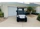 Charming home exterior featuring a golf cart parked near the garage and well-maintained landscaping at 1087 Jackson St, The Villages, FL 32162