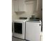 Modern laundry room featuring new white front load washer and dryer at 1087 Jackson St, The Villages, FL 32162