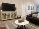 Living room featuring hardwood floors, modern entertainment center, and comfortable seating at 1087 Jackson St, The Villages, FL 32162