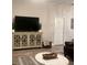 Living room featuring hardwood floors, modern entertainment center, and comfortable seating at 1087 Jackson St, The Villages, FL 32162