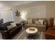 Inviting living room featuring neutral furniture, decorative rug, and plantation shutters for a cozy atmosphere at 1087 Jackson St, The Villages, FL 32162