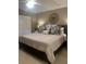 Spacious primary bedroom with a king bed, decorative pillows, and a stylish round mirror over the headboard at 1087 Jackson St, The Villages, FL 32162